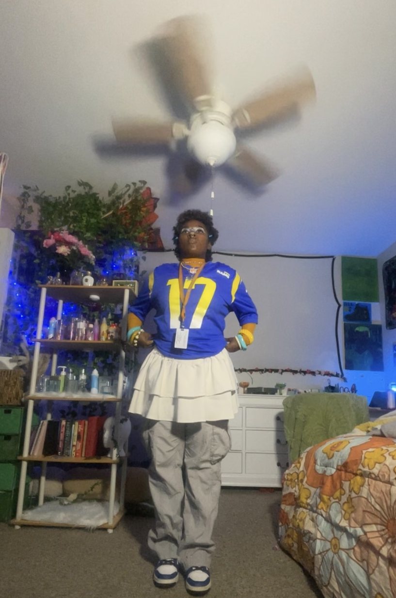 Nelle in a blue 17 jersey, white tiered skirt and cargos